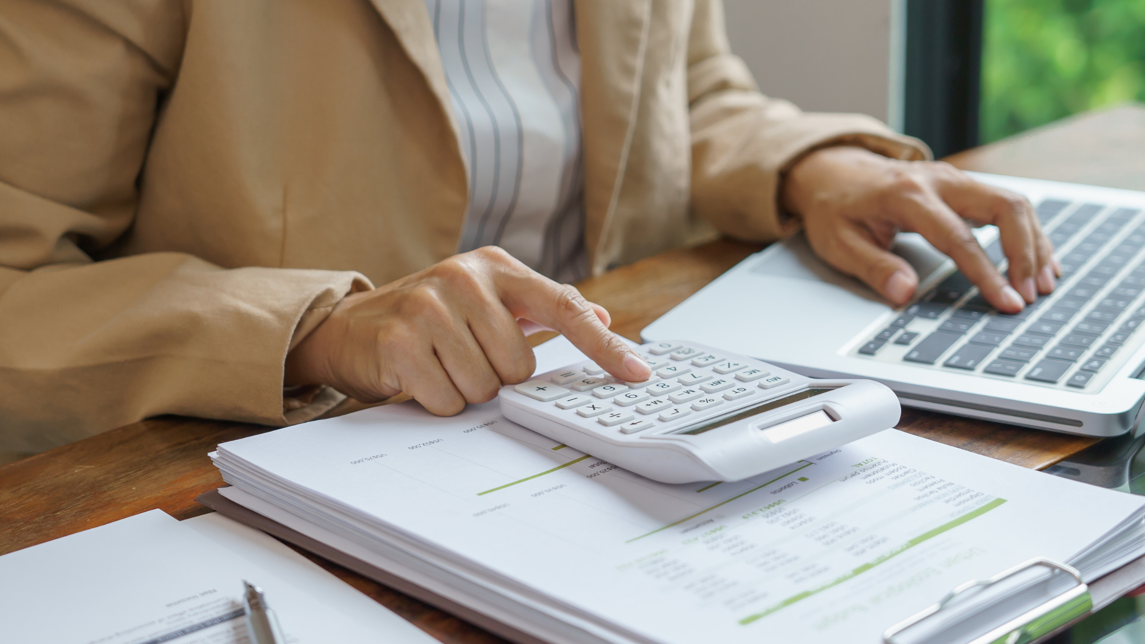 Bills and calculator spread out across desk