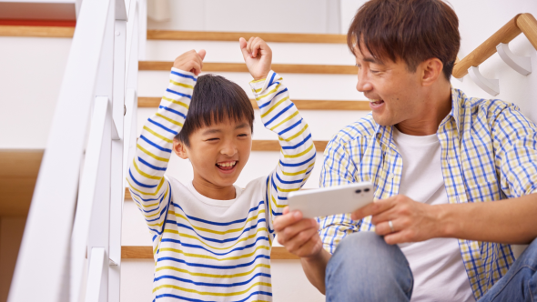 Kid celebrating win as Dad shows something exciting on phone