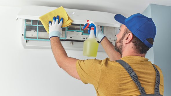 Man in yellow installing AC unit