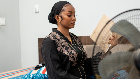 Woman fanning herself during heatwave