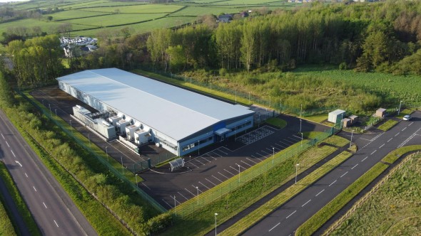 Data center building on green rural background
