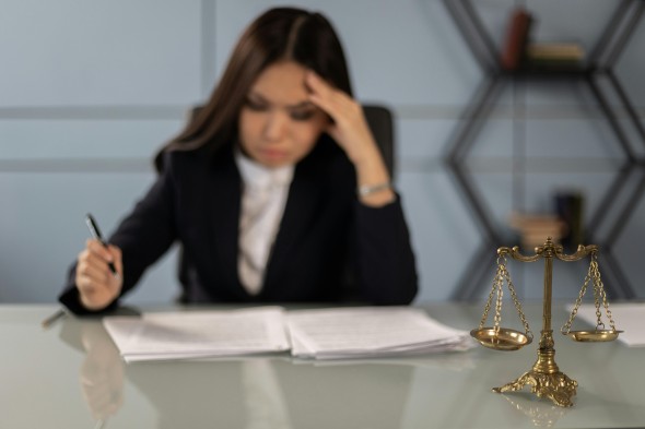 Lawyer sits at her desk looking over papers