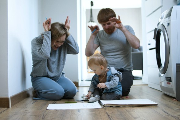 Family playing by a washing machine