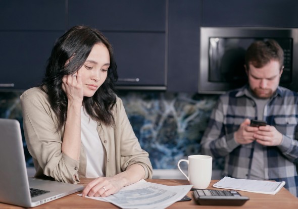 Couple looks stressed over a bill