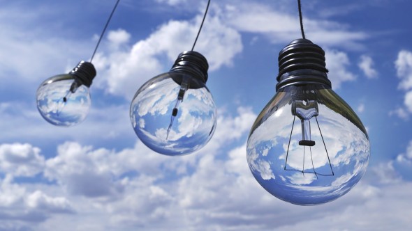 Light bulbs against a blue sky with white clouds